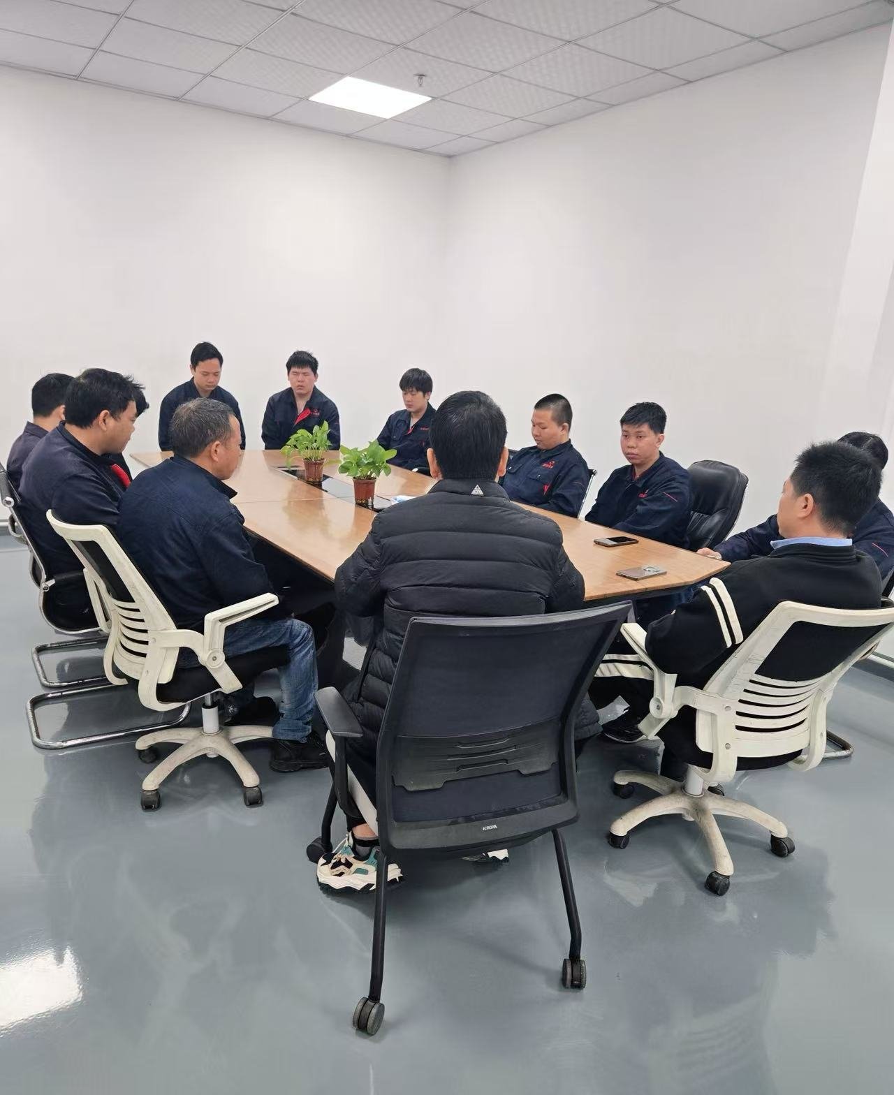 LINFENG team members gathered around a conference table for a meeting