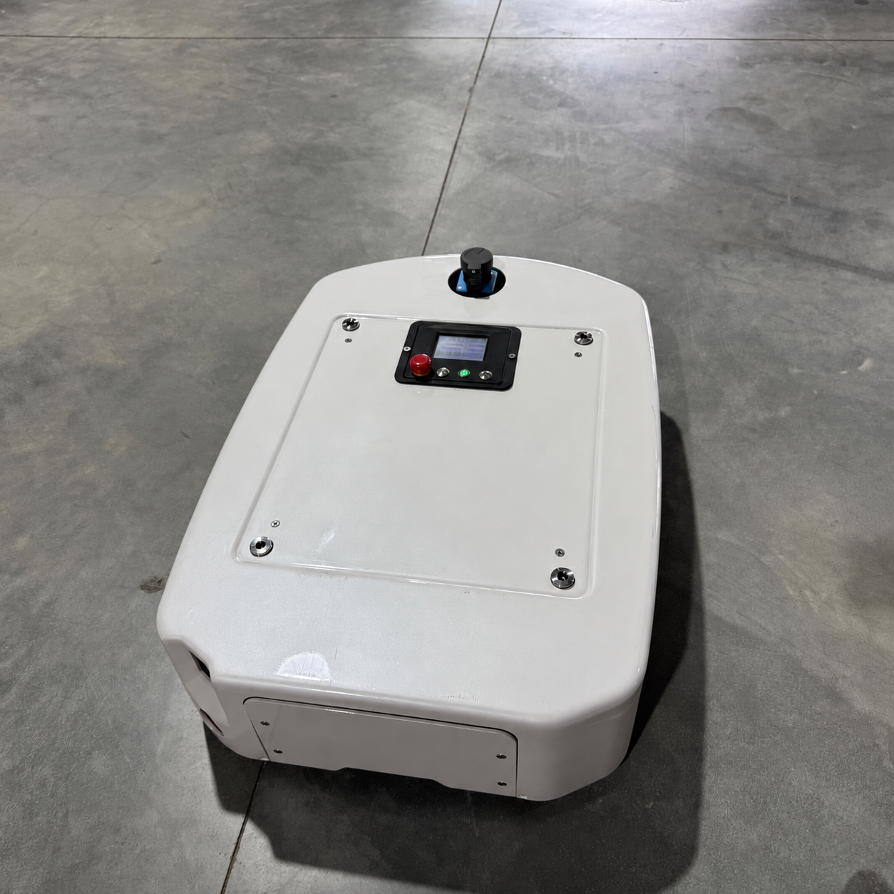 Front view of the white AGV chassis on a workshop floor