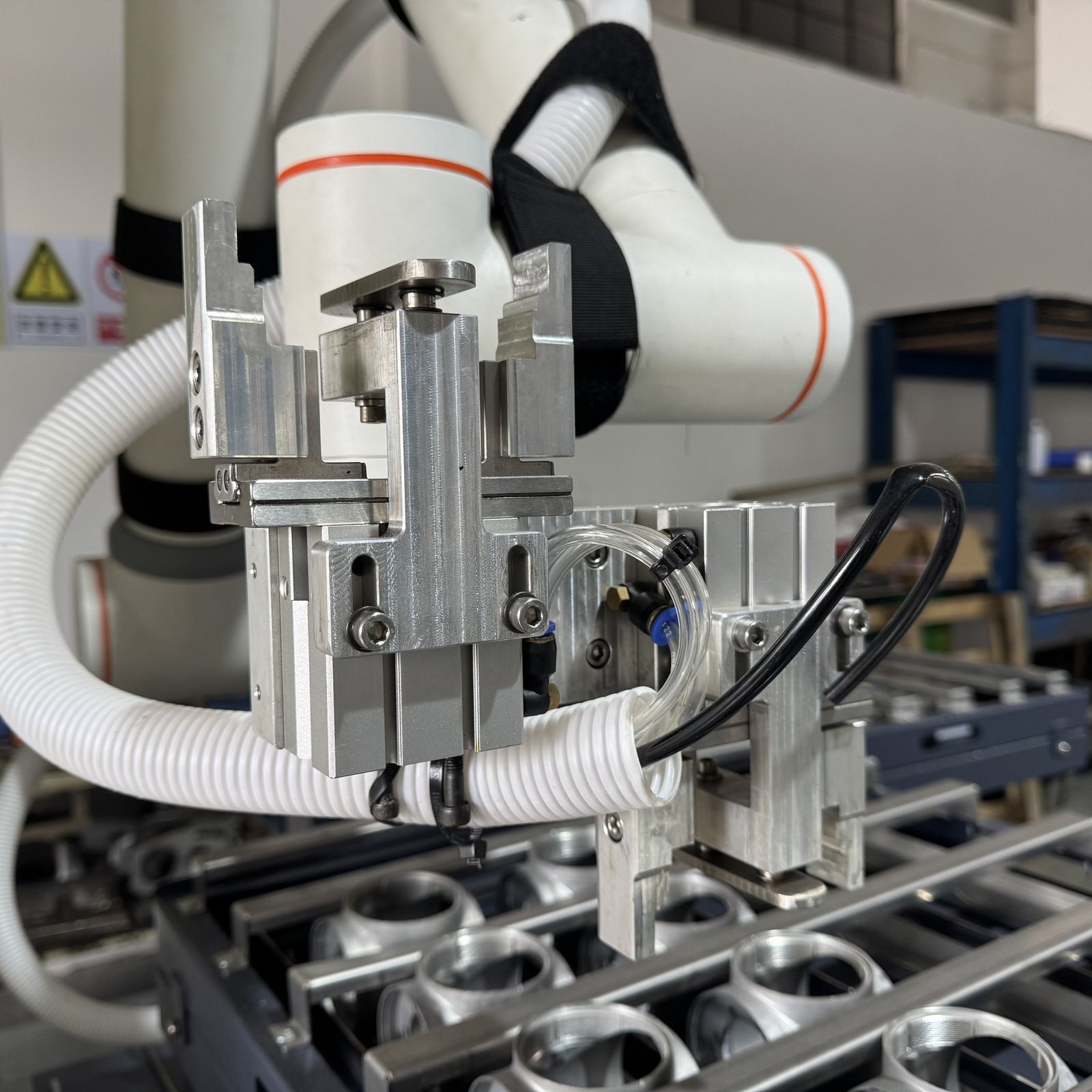 Close view of the machine tending gripper and pneumatic tooling