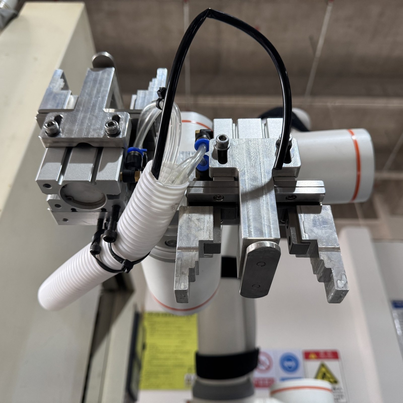 Underside view of the machine tending robot gripper